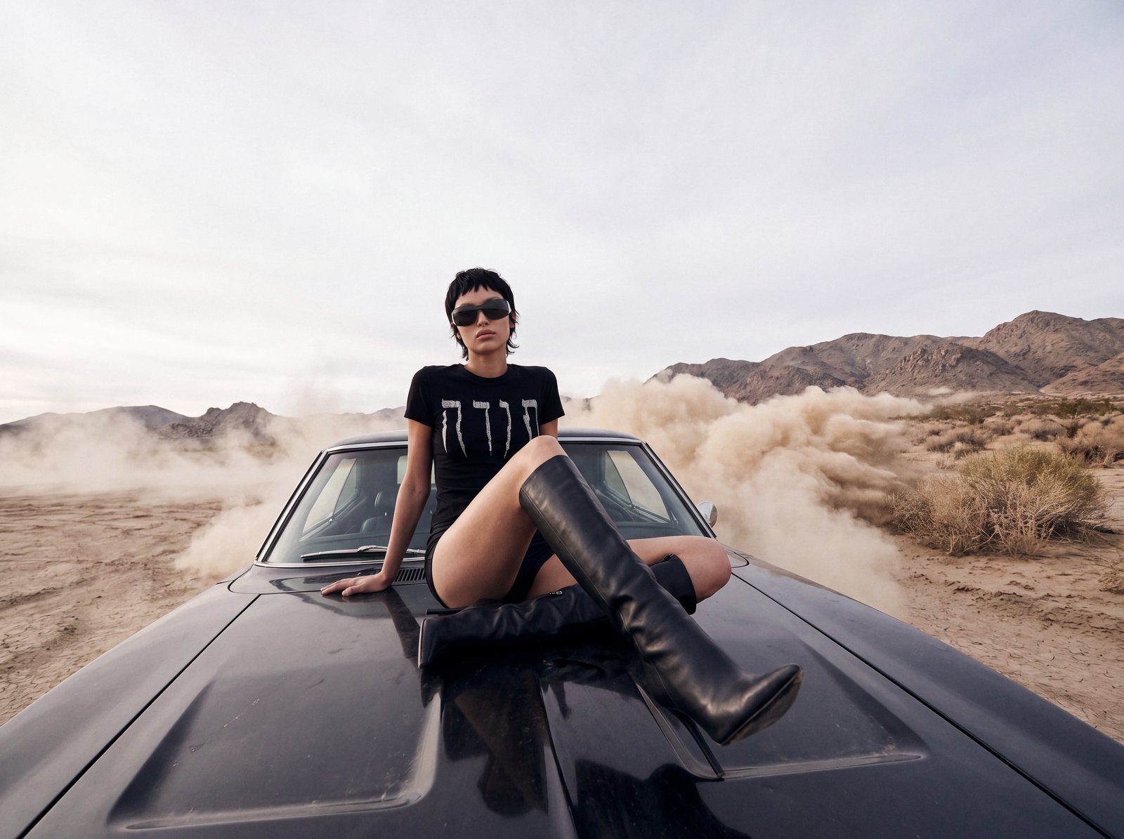Desert editorial: model seated on the car hood